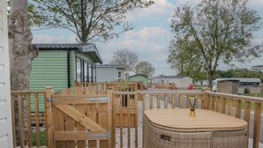 A wooden deck with a wicker basket and a wooden gate. - Labernum (Preston)