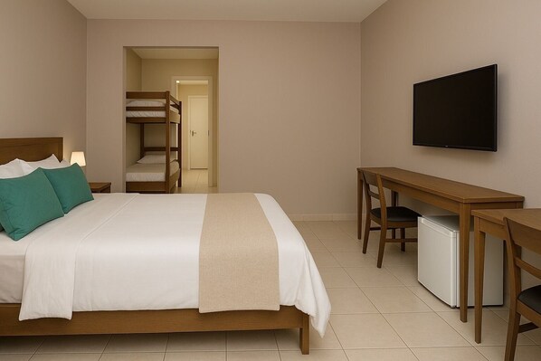 A hotel room with a bed, a desk, a television, and a kitchenette. - Pousada Vila Lençóis e Sport (Barreirinhas)