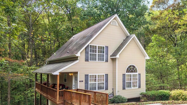 A two-story house with a porch, a deck, and a driveway. - La Casita- Trailside Retreat in Collegedale (Collegedale)