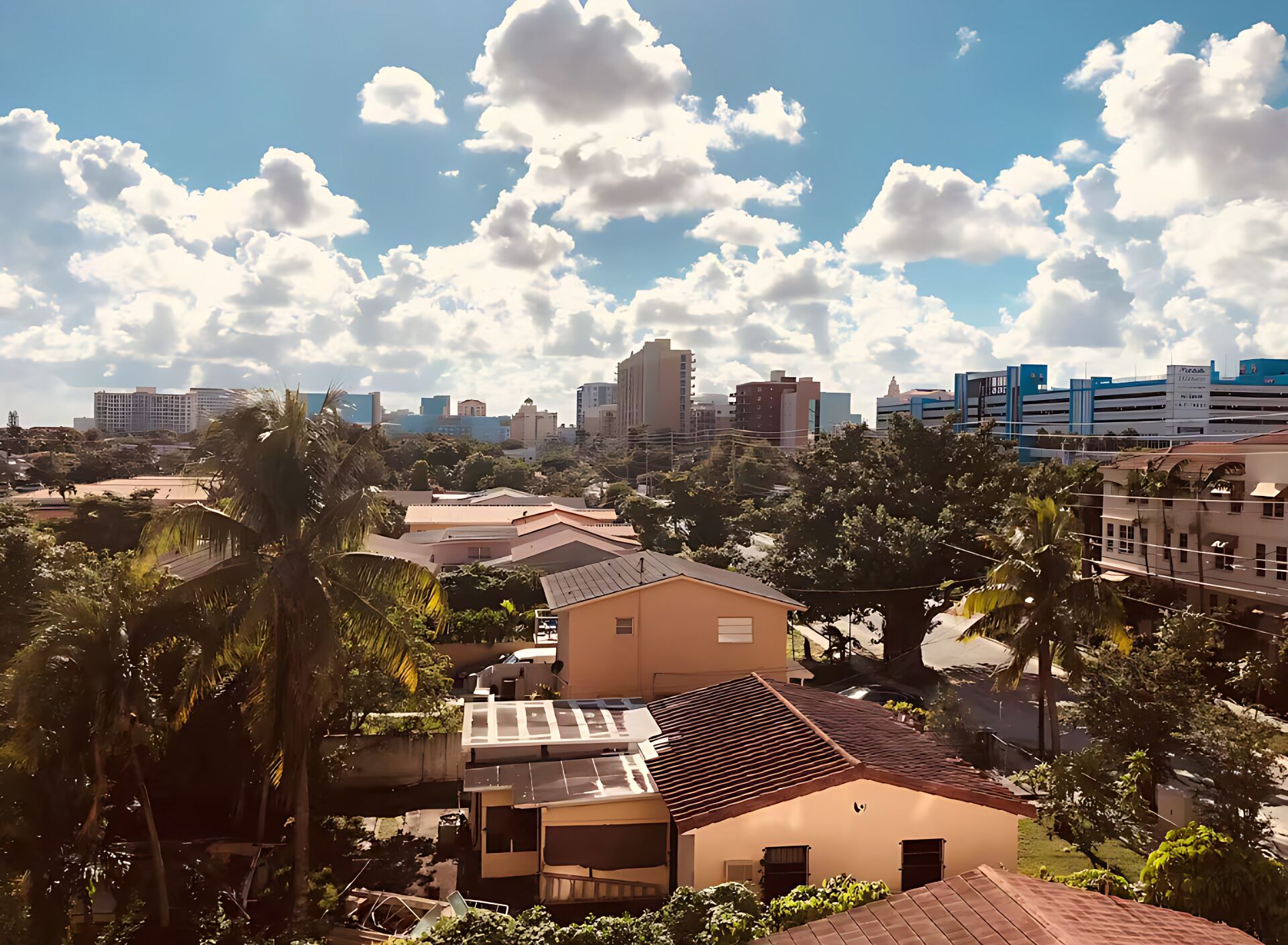 A cityscape with a mix of residential and commercial buildings, including a prominent high-rise and several mid-rise structures.