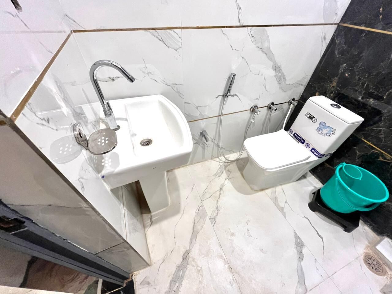 A bathroom with a white sink, a toilet, and a shower.
