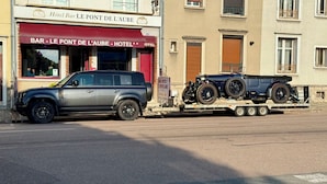 A grey SUV parked in front of a building with a red awning and a sign that reads "Hotel Bar Le Pont De L'Aube". - Hôtel Restaurant Le Pont de l'Aube (Arcis-sur-Aube)