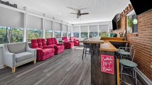 A modern interior with a bar area, seating, and large windows. - Retro Style River house in Milton Florida on Beautiful Black Water River.  (Milton)