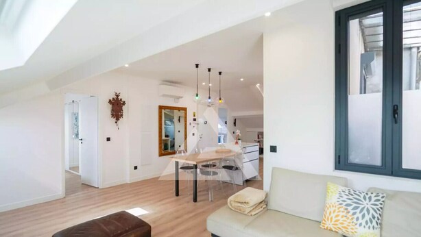 A spacious living area with a sofa, ottoman, dining table, and chairs. - Monaco Border - 100% new with see view (Beausoleil)