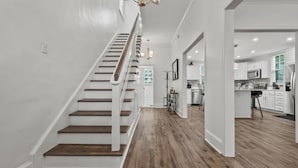 A modern kitchen with white cabinets, stainless steel appliances, and a central island. - Perfect Get-Away In The Heart Of Downtown Florence (Florence)