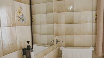 Bathtub, hair dryer, towels, soap