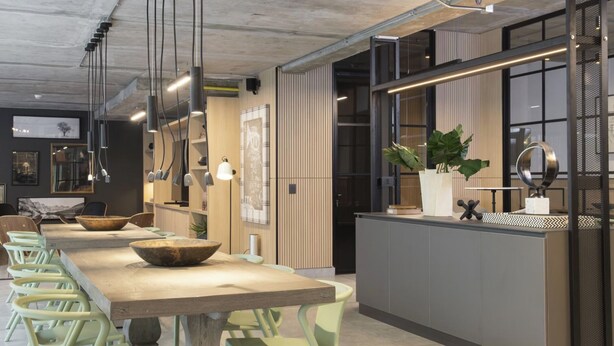 A modern kitchen with a long island, bar stools, pendant lighting, and a large window. - Corporate Stays Somma Asturias (Santiago)