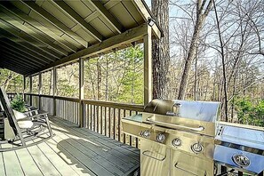 A covered outdoor deck with a grill and seating area. - Luxury 3BR Retreat in Big Canoe-Hedgehog Hollow (Jasper)