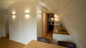 A compact kitchen with wooden cabinets and a built-in sink.