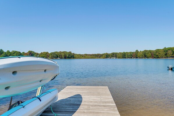 A wooden dock extending into calm water with boats moored on the left. - 13 Mi to South Haven: Lakefront Retreat w/ Dock! (Grand Junction)