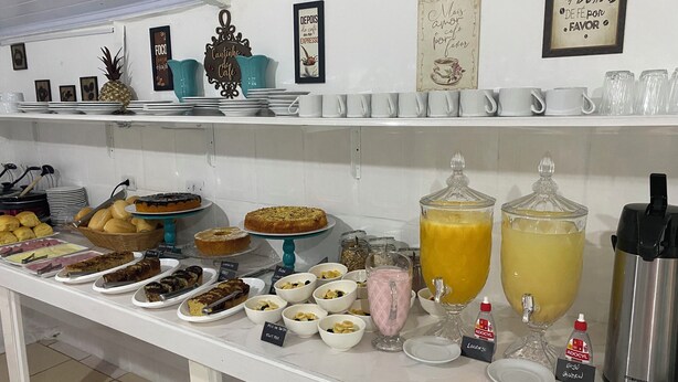 A buffet setup with various food items and beverages.
