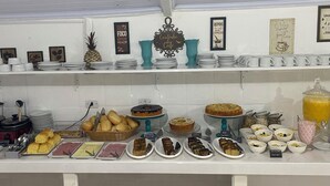 A buffet setup with various food items and a coffee station. - Pousada Real Paraty (Paraty)