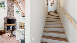 A staircase with wooden steps and a handrail, leading to an upper floor.
