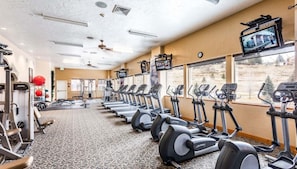 A gym with treadmills, stationary bikes, and weight machines.