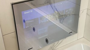 A Smart TV with a user interface displaying 'What's New' and 'Featured App' sections.