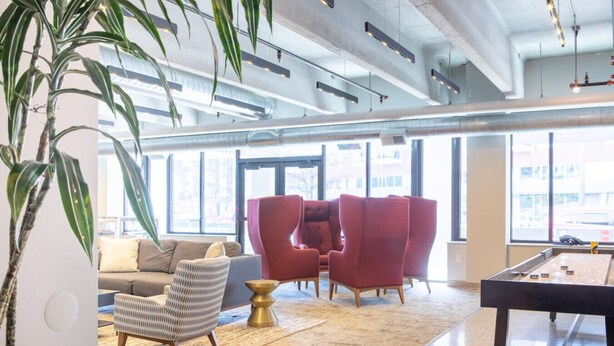 A modern lounge area with a sofa, armchairs, a coffee table, and a pool table. - East Side Studio Apt - Near Brady St and Fiserv with Balcony (Milwaukee)
