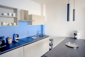 Fridge, stovetop, dishwasher, coffee/tea maker