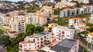 A residential area with multi-story buildings, some with balconies, and a mix of architectural styles.