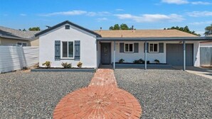 A two-story house with a gravel driveway and a red circular pattern in the center. - Riverside Dream House (Riverside)