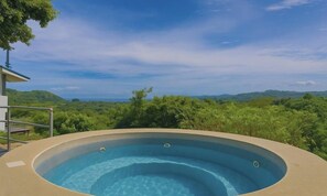 A hot tub with a view of a lush landscape. - Endless Ocean Views 4 bedroom suites, Private Pool, minutes from downtown Coco (Coco)