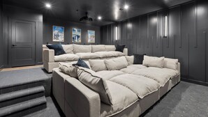 A modern living room with a sectional sofa, a small coffee table, and a staircase leading to a lower level.