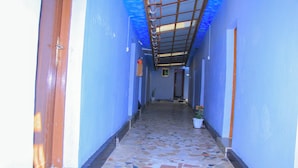 A narrow hallway with blue walls and a tiled floor. - HAPPY CLASSIC LODGE MBEYA (Mbeya)