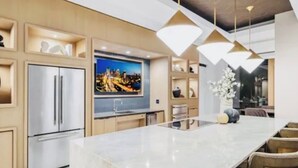 A modern kitchen with a large island, built-in appliances, and pendant lighting. - Elite Resort Home • Pool, Jacuzzi, Basketball • Sleeps 16+ King Beds•Shuttle (Everett)
