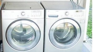 Two stacked front-loading washing machines in a laundry area with a window above. - -Relaxing 80 Acre Studio Space- (Groveland)
