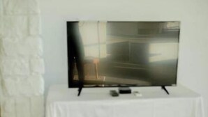 A television on a white table against a white wall. - -Relaxing 80 Acre Studio Space- (Groveland)