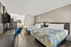 A hotel room with two beds, a desk, a chair, and a TV. - Motel 6 – Mccomb, Ms (McComb)