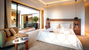 A modern hotel room with a large bed, a sofa, a coffee table, and a view of the outdoors. - Villa Harmonie Luxe & Bien-être in the golf residence with spa (Marrakech)