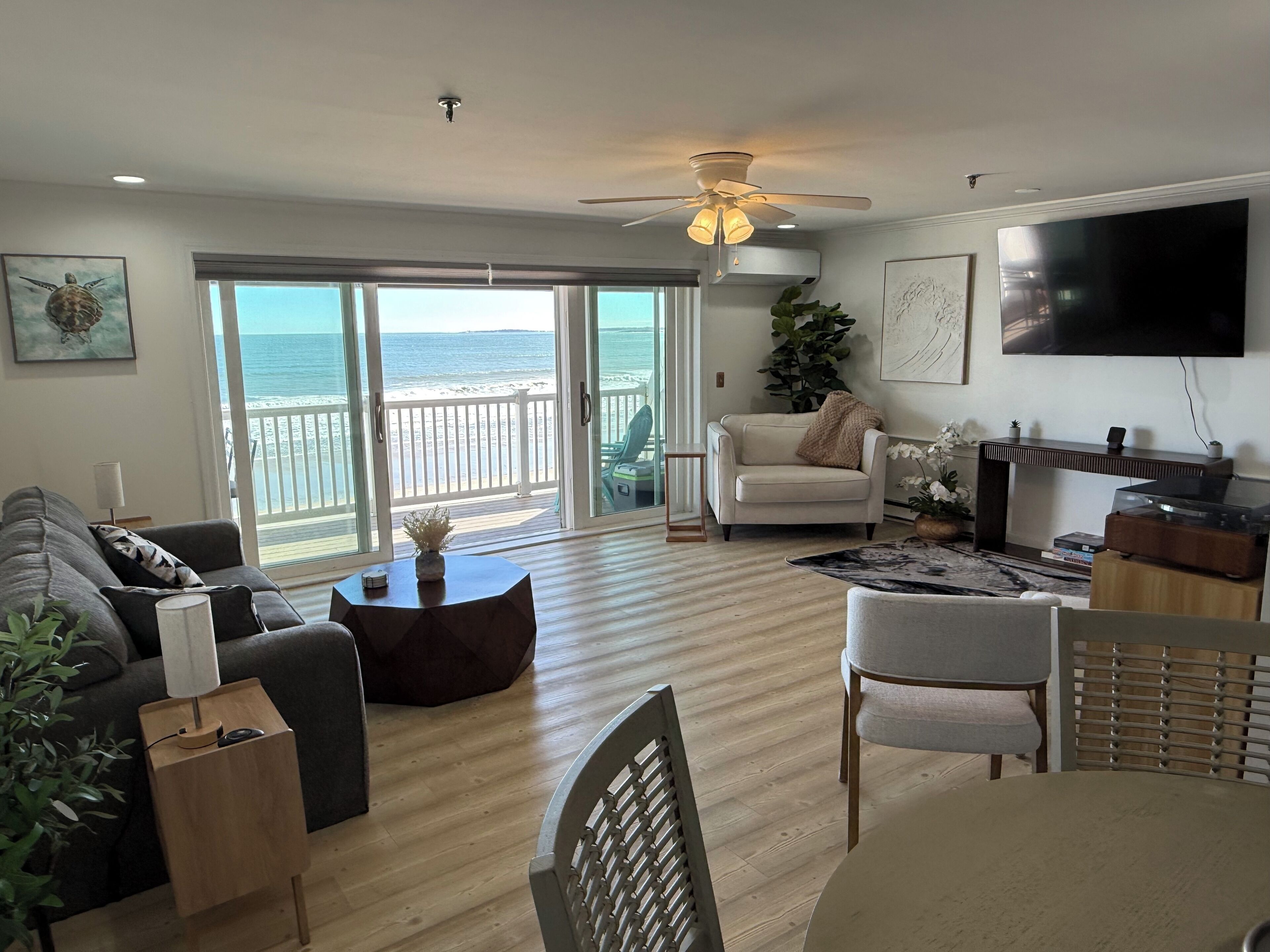 View of the living room and oceanfront balcony from the dining area