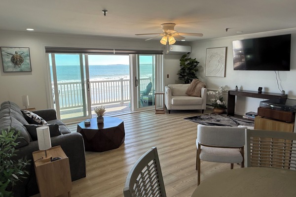 View of the living room and oceanfront balcony from the dining area