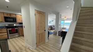 A modern kitchen with wooden cabinets, a stainless steel oven, and a microwave. - The Brunswick Penthouse with Panoramic Oceanfront Balconies-2 bedroom/2.5 bath (Old Orchard Beach)