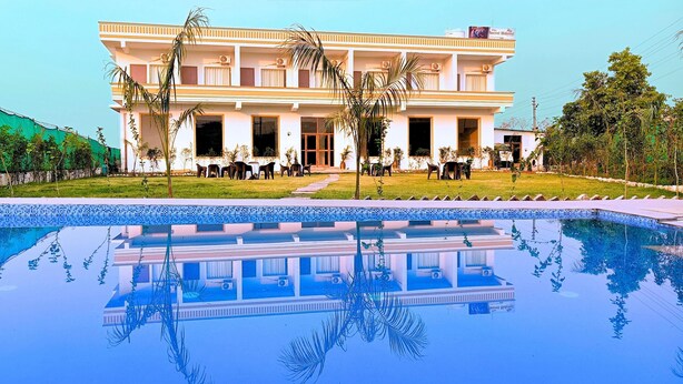 A two-story building with a swimming pool in front. - Foreste Resort (Ramnagar)