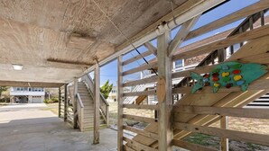 A covered wooden structure with a staircase leading to an upper level. - Little Island Time: Walk to Beach Retreat (Kitty Hawk)