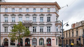 A historic building with classical architecture, featuring multiple windows and a central entrance.