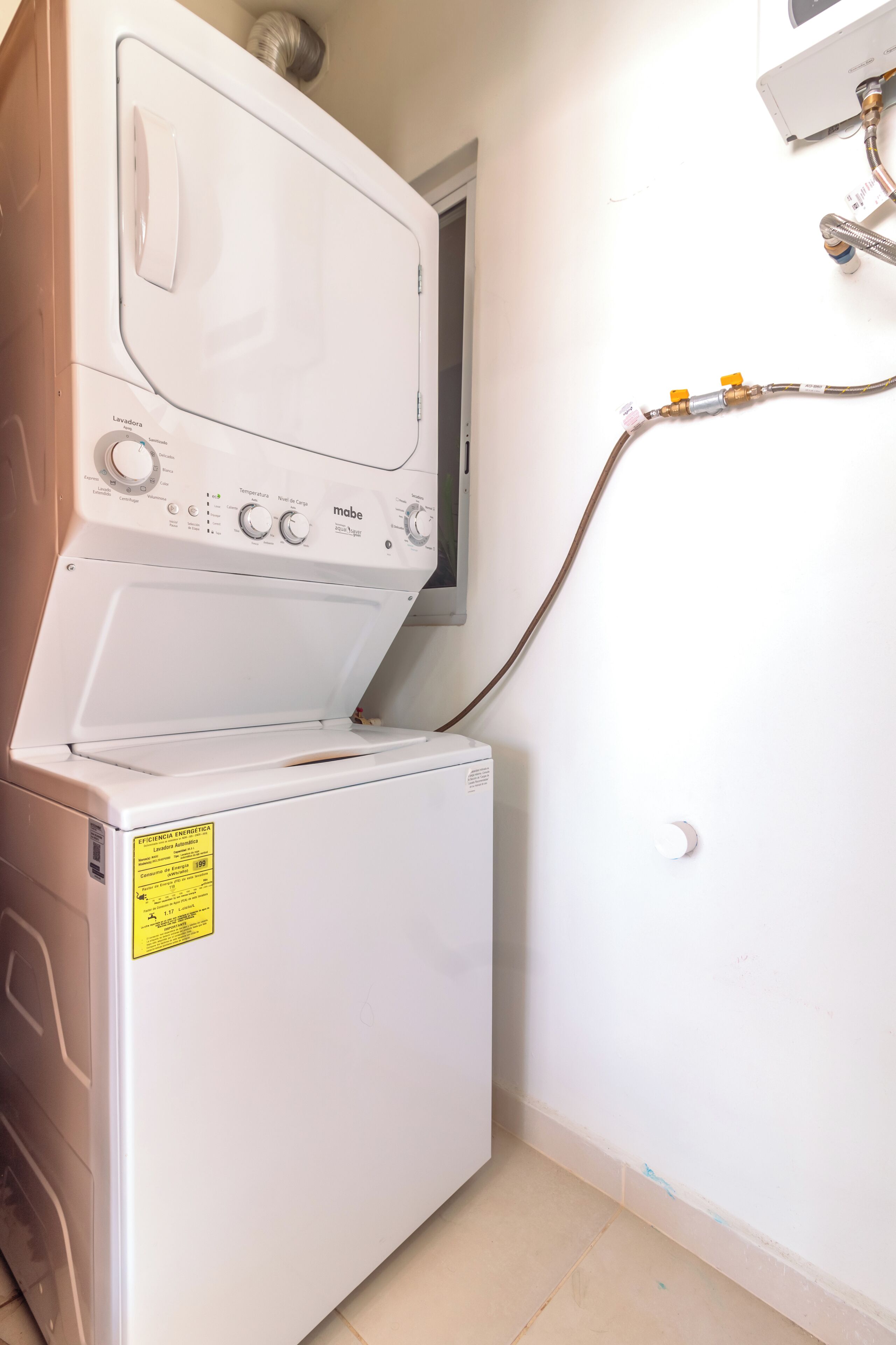 A white washing machine with a control panel and a yellow sticker.