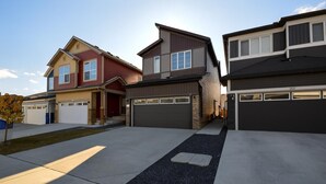 A residential area with three houses, each with a garage. The houses have different architectural styles and colors. - CASA BOHO I Cozy Boho Retreat in NW Calgary (Calgary)