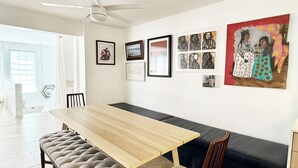 A dining area with a wooden table, cushioned bench, and chairs.