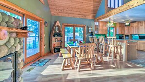 A spacious kitchen with wooden cabinets and a dining area with rustic chairs.