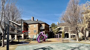 A playground with a basketball court, swings, and a slide. - The Grove Getaway-Centrally Located (Pleasant Grove)