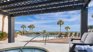 A pool area with a hot tub, lounge chairs, and a pergola with lights. - Beautiful Marriott 2-bedroom villa with AC, fitness room on Hilton Head Island (Hilton Head Island)