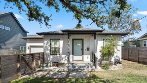 A residential house with a front porch, a garage, and a fenced yard. - Spacious 3BR w Parking Pet Friendly (Austin)