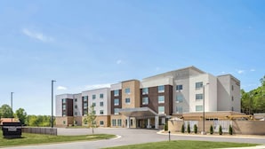 A modern hotel with a central entrance, multiple floors, and a parking area. - Towneplace Suites by Marriott Kernersville (Kernersville)