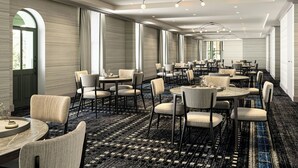 A spacious hotel dining area with round tables and chairs, large windows, and a patterned carpet. - The Union Hotel, Flemington, A Tribute Portfolio Hotel (Flemington)