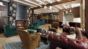 A spacious living area with a fireplace, plush seating, and a modern ceiling design. - The Union Hotel, Flemington, A Tribute Portfolio Hotel (Flemington)