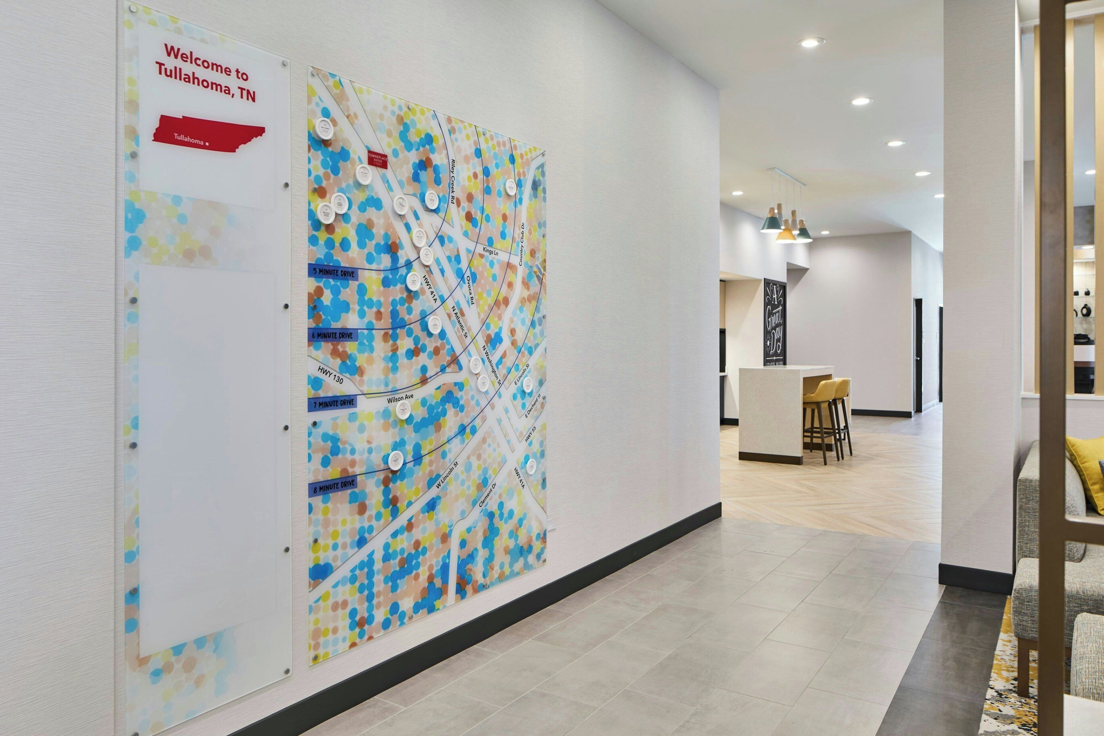 A hallway with a map, a reception area, and a bar.