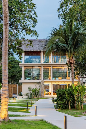 A modern two-story building with large windows, a pathway leading to the entrance, and surrounding greenery. - Samaraya Wellness Resort (Koh Samui)