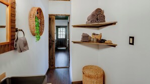 A hallway with a wooden ceiling, a mirror, a woven basket with a plant, and shelves with towels. - < 1 Mi to Downtown Arcadia: Tranquil Wooded Escape (Arcadia)